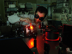 Male professor working with lasers in a lab